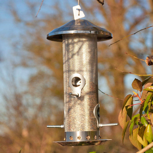A stainless steel bird feeder with rain guard and squirrel proof clip to keep the lid closed.