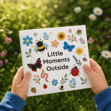 Little Moments Outside children's nature book being held by small hands in a garden setting with flowers
